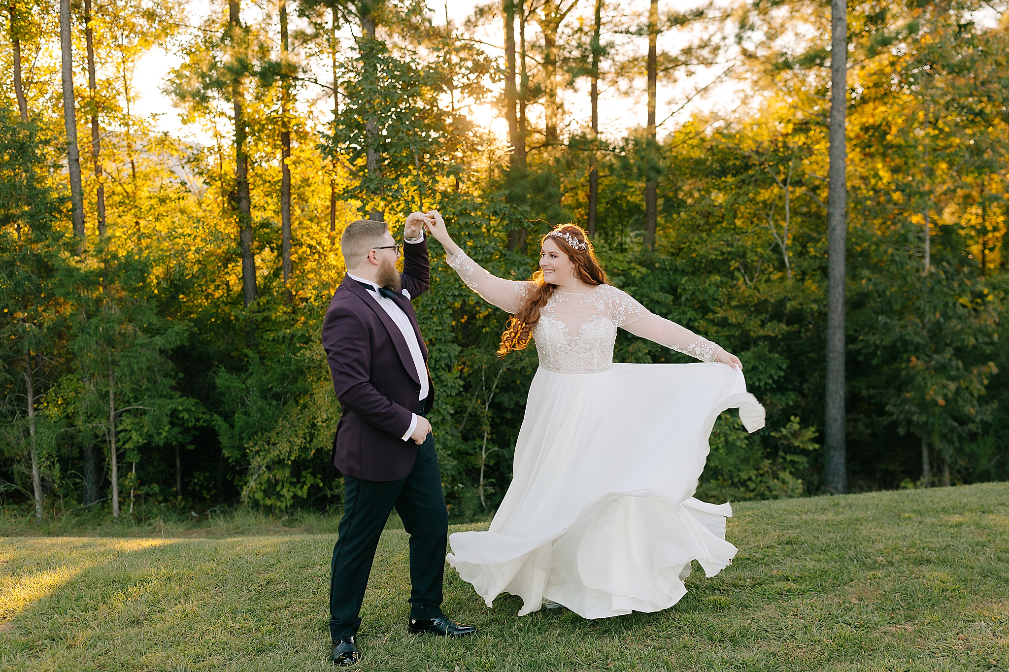 groom in plum jacket twirls bride