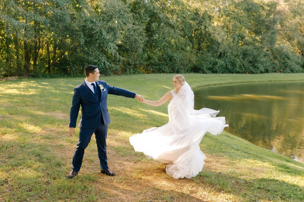 Bride twirling in her wedding dress at Camellia Gardens in Monroe, NC