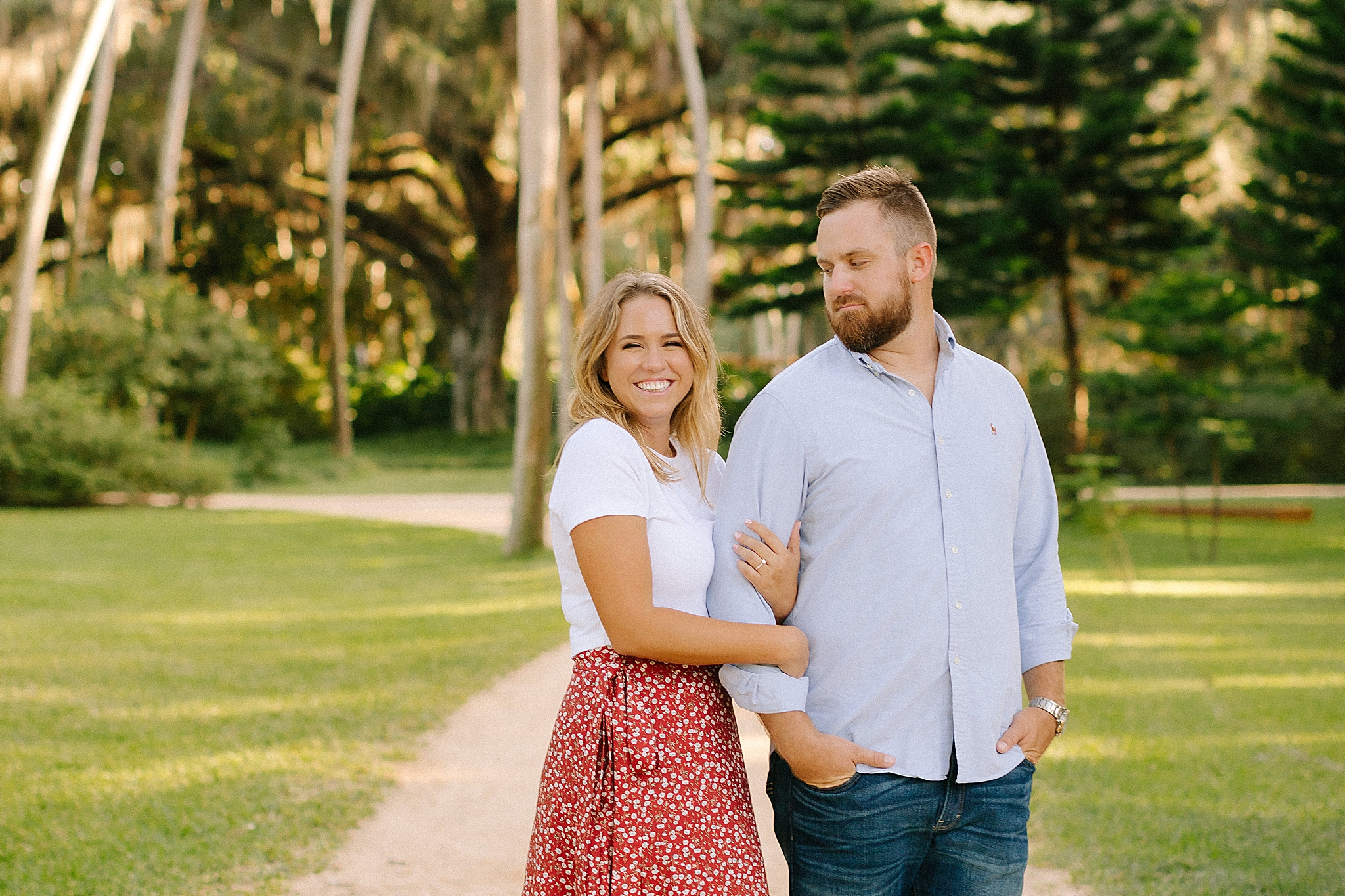 groom looks at bride during Florida engagement session