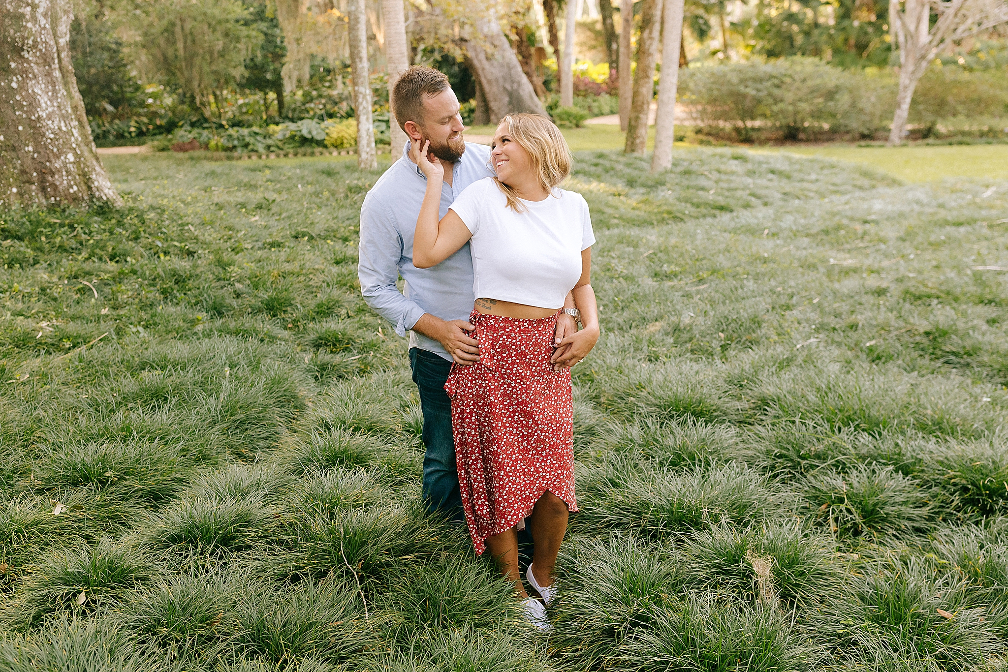 bride looks back at groom during Florida engagement session