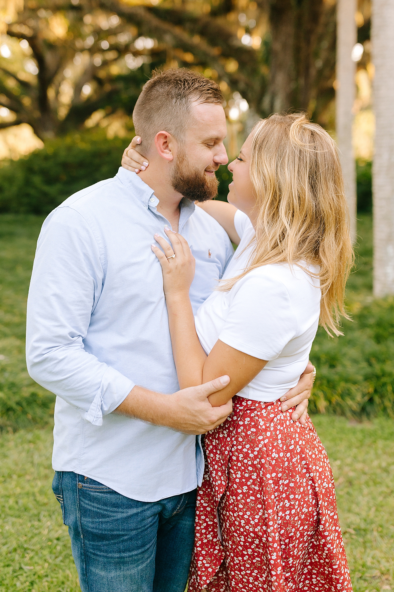 bride and groom stand nose to nose during FL engagement session