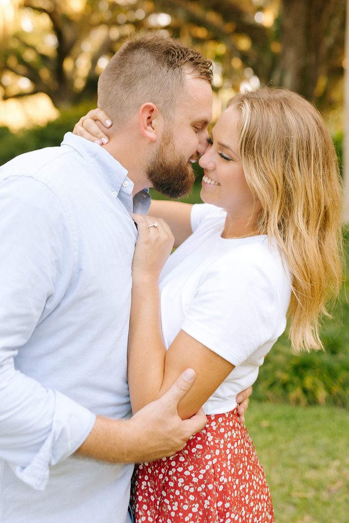 groom kisses bride's cheek during FL engagement session