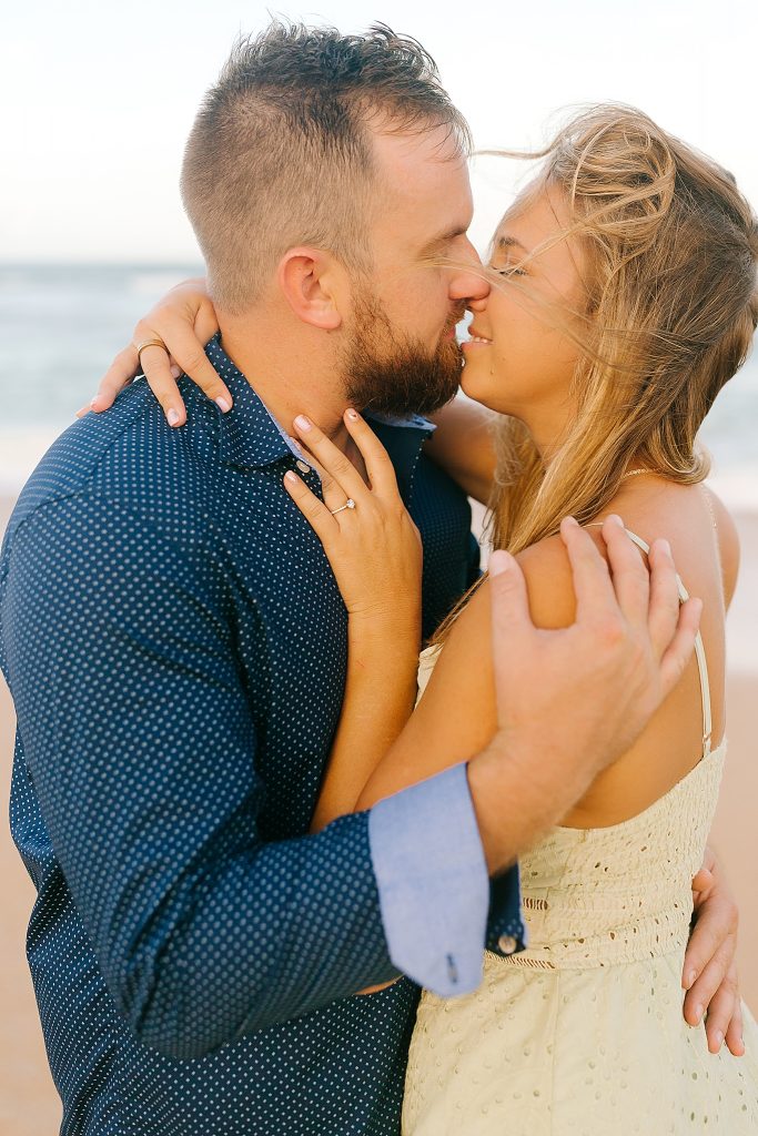 bride and groom kiss during Florida beach engagement session