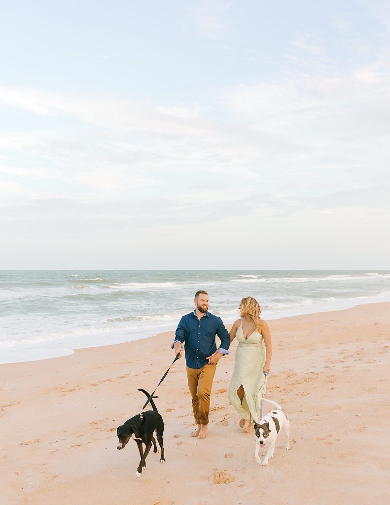 bride and groom walk dogs on Palm Coast beach