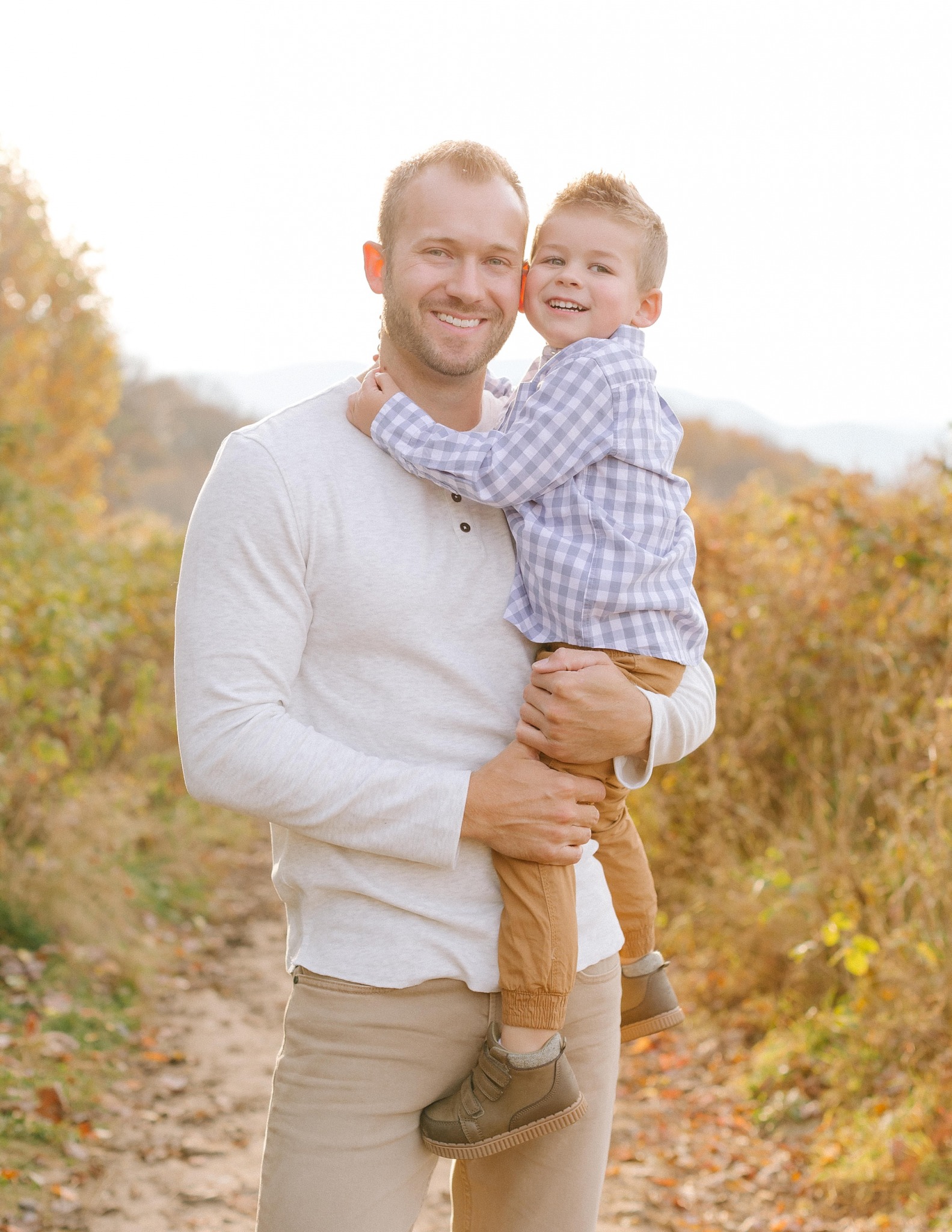 dad and son pose together at Max Patch during family photos