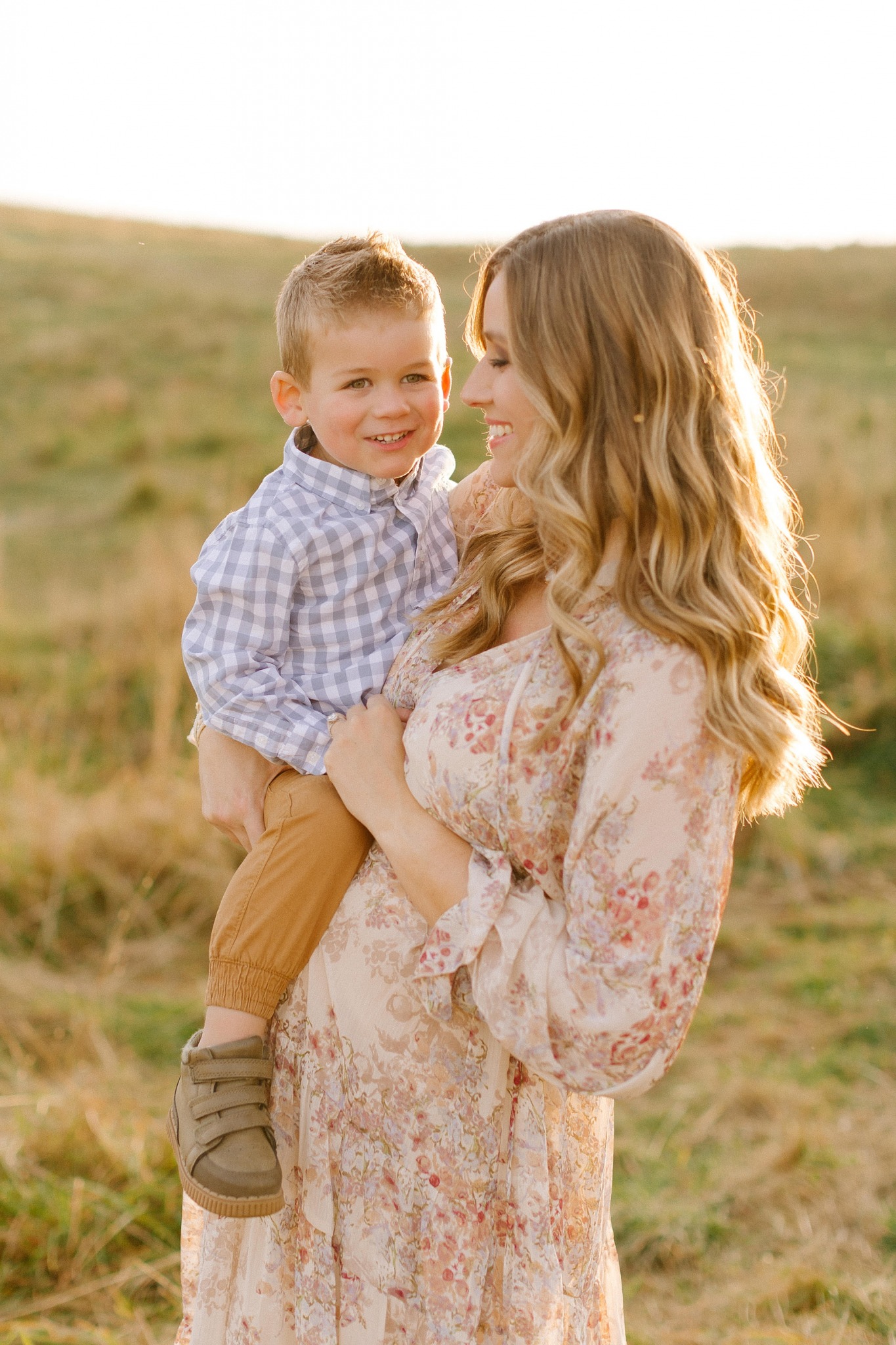 sunset maternity session at sunset with mom and son