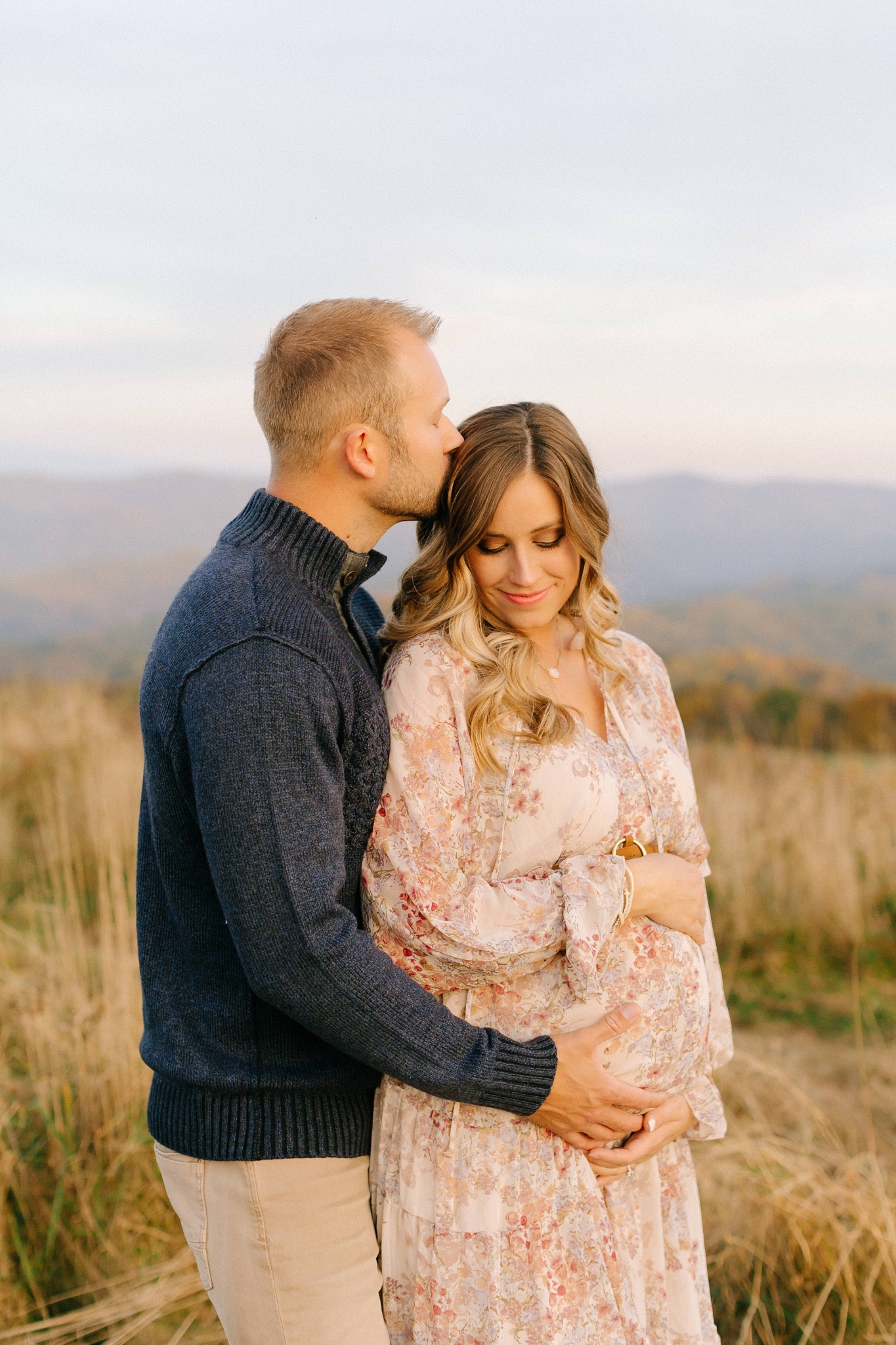 husband kisses wife's head during Asheville maternity session