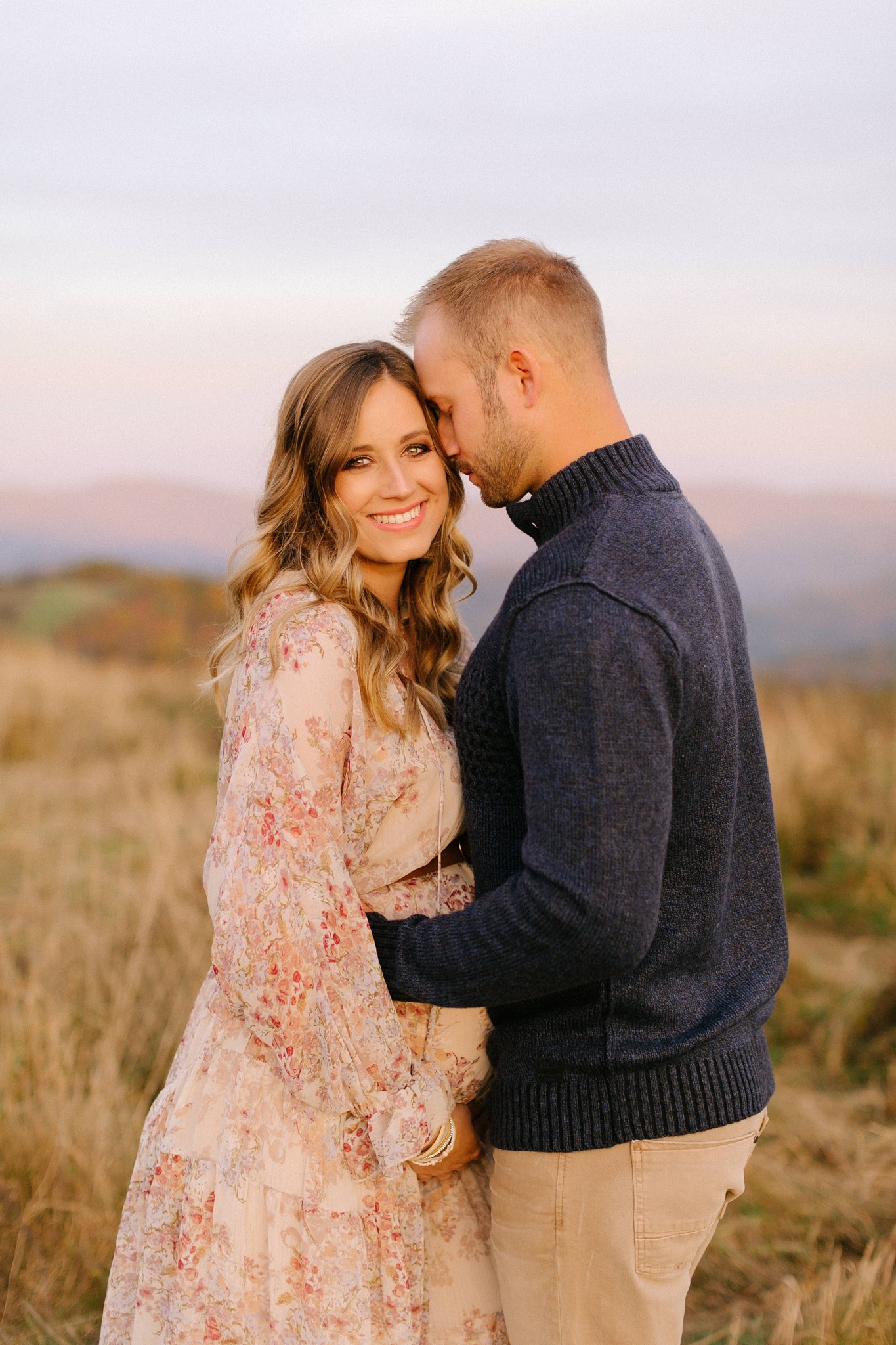 husband leans against wife during Asheville maternity session