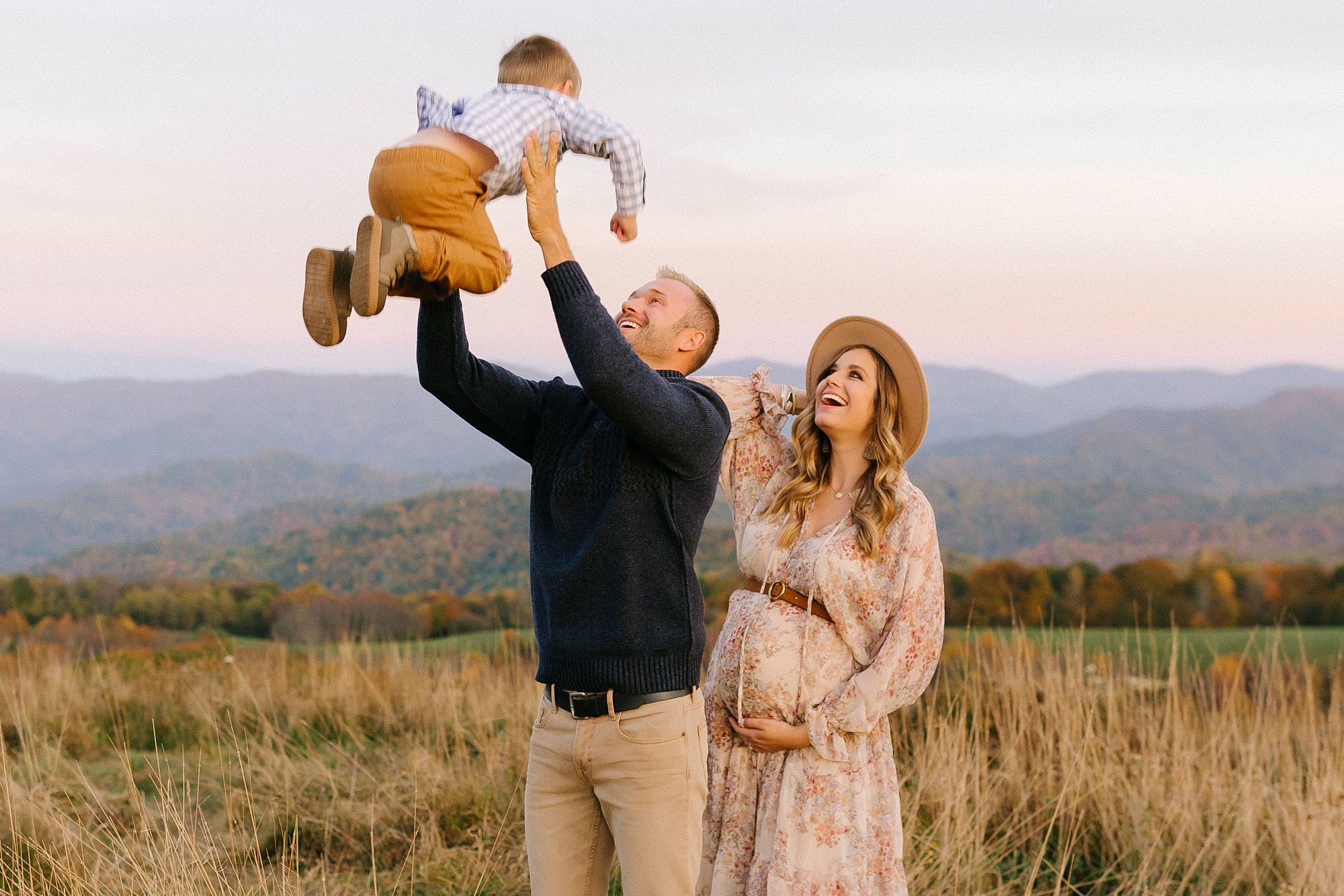 dad throws son in the air during NC maternity session 
