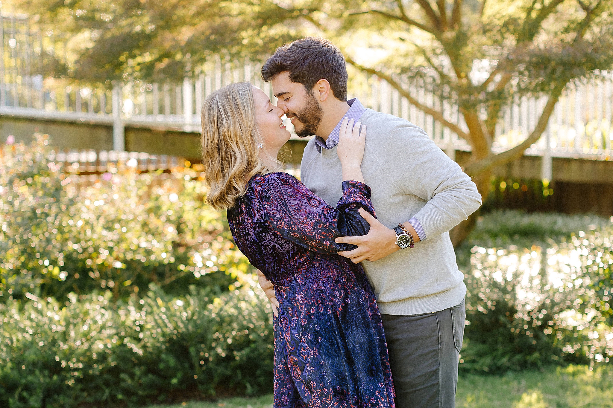 couple kisses in Raleigh NC park during engagement photos
