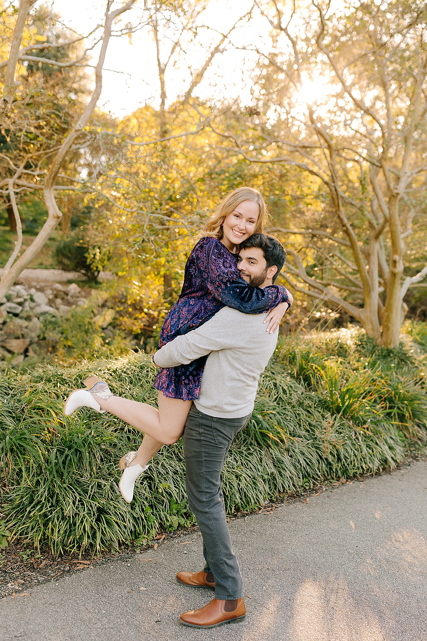 groom lifts bride up during engagement photos in Raleigh NC