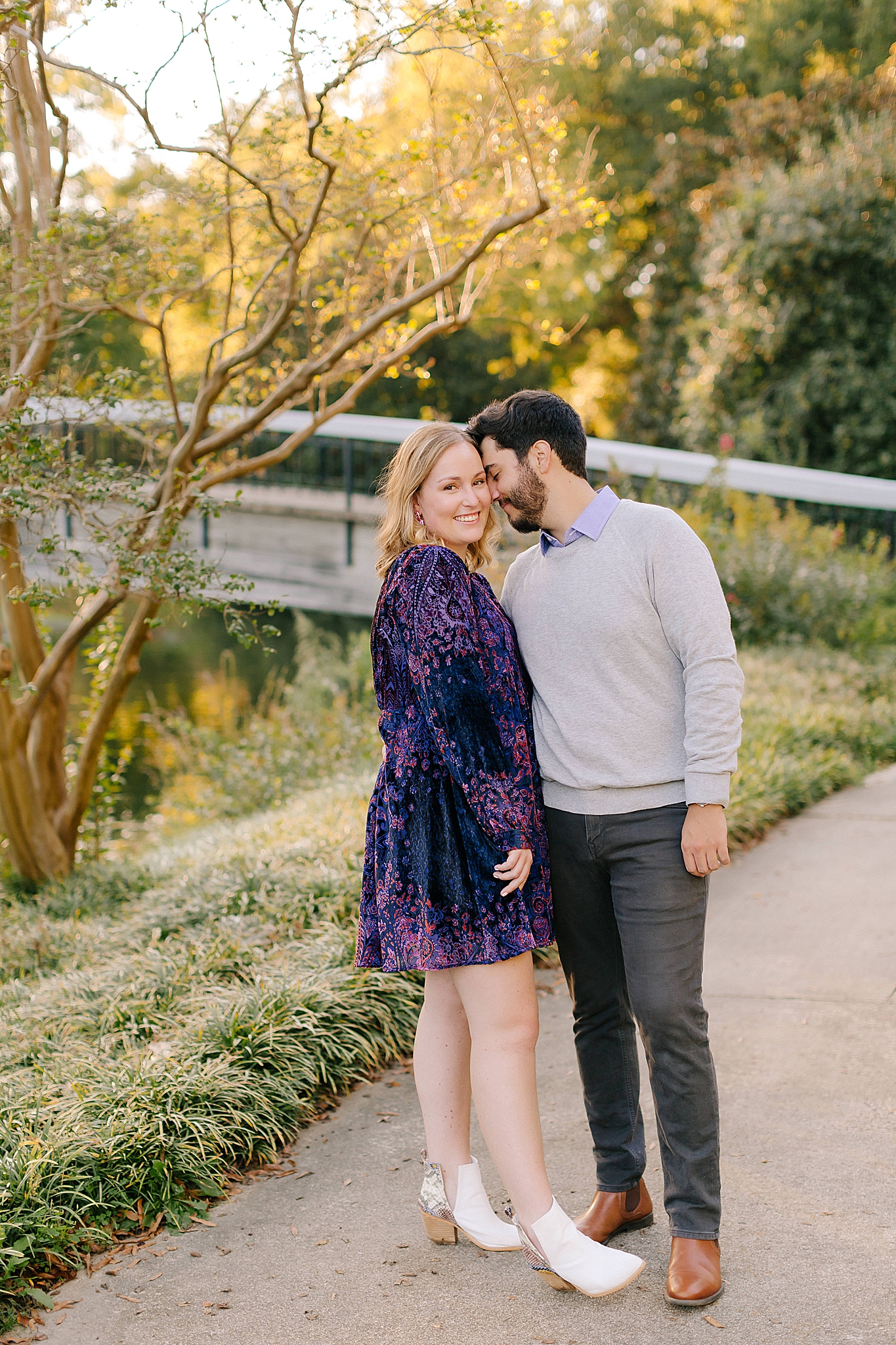 groom nuzzles bride's cheek during NC engagement photos in Raleigh