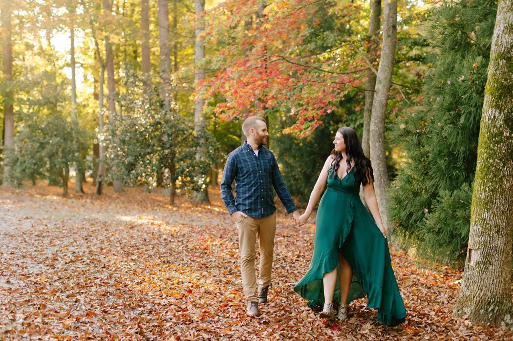 married couple walks through woods at Greensboro Botanical Gardens