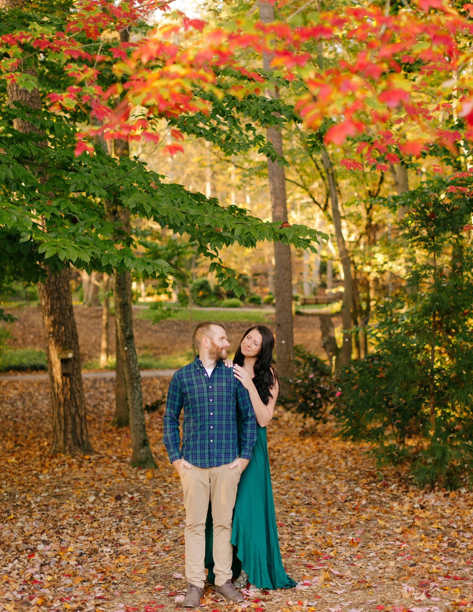 married couple poses together in woods at Greensboro Botanical Gardens