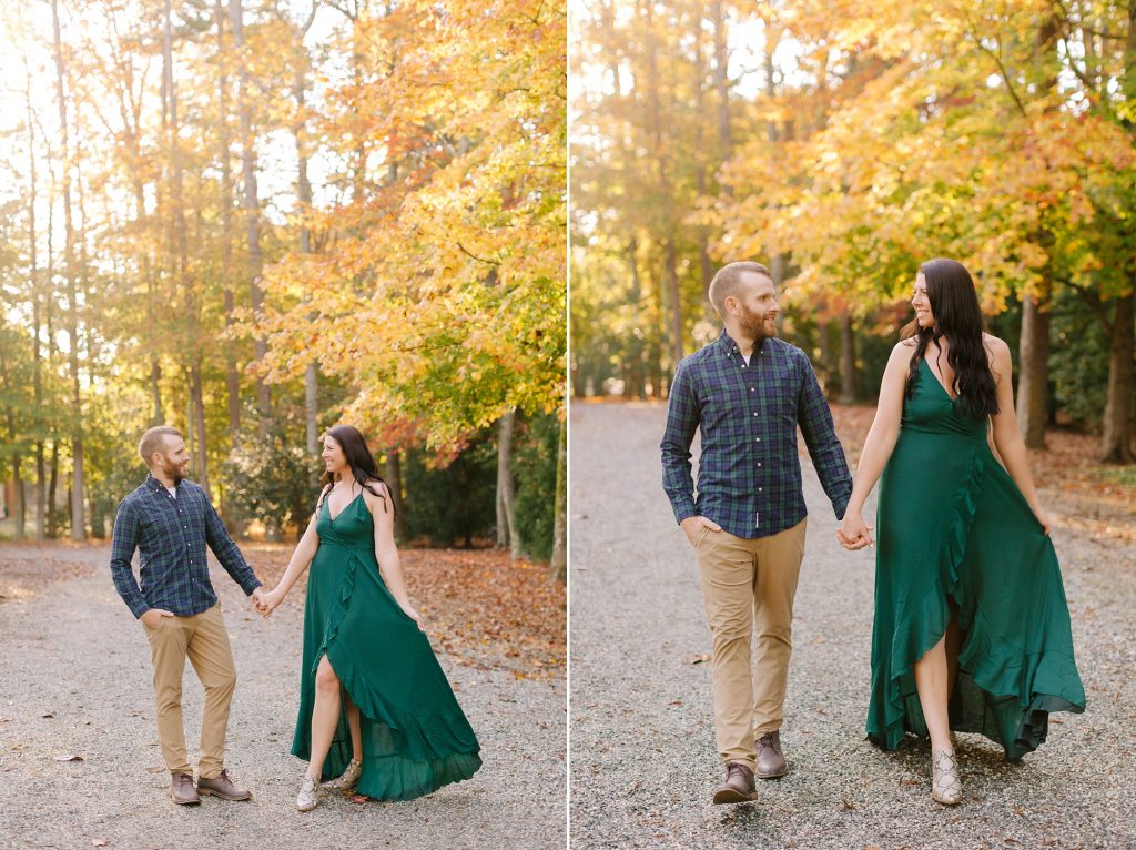 married couple walks through fallen leaves at Greensboro Botanical Gardens