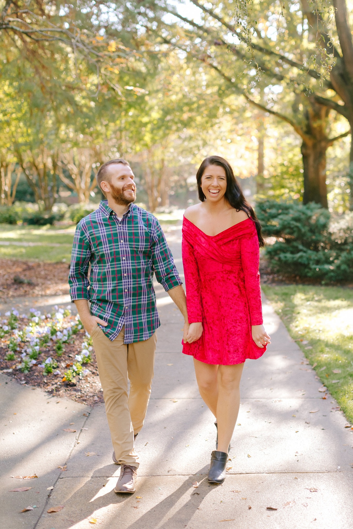 married couple laughs walking through botanical gardens
