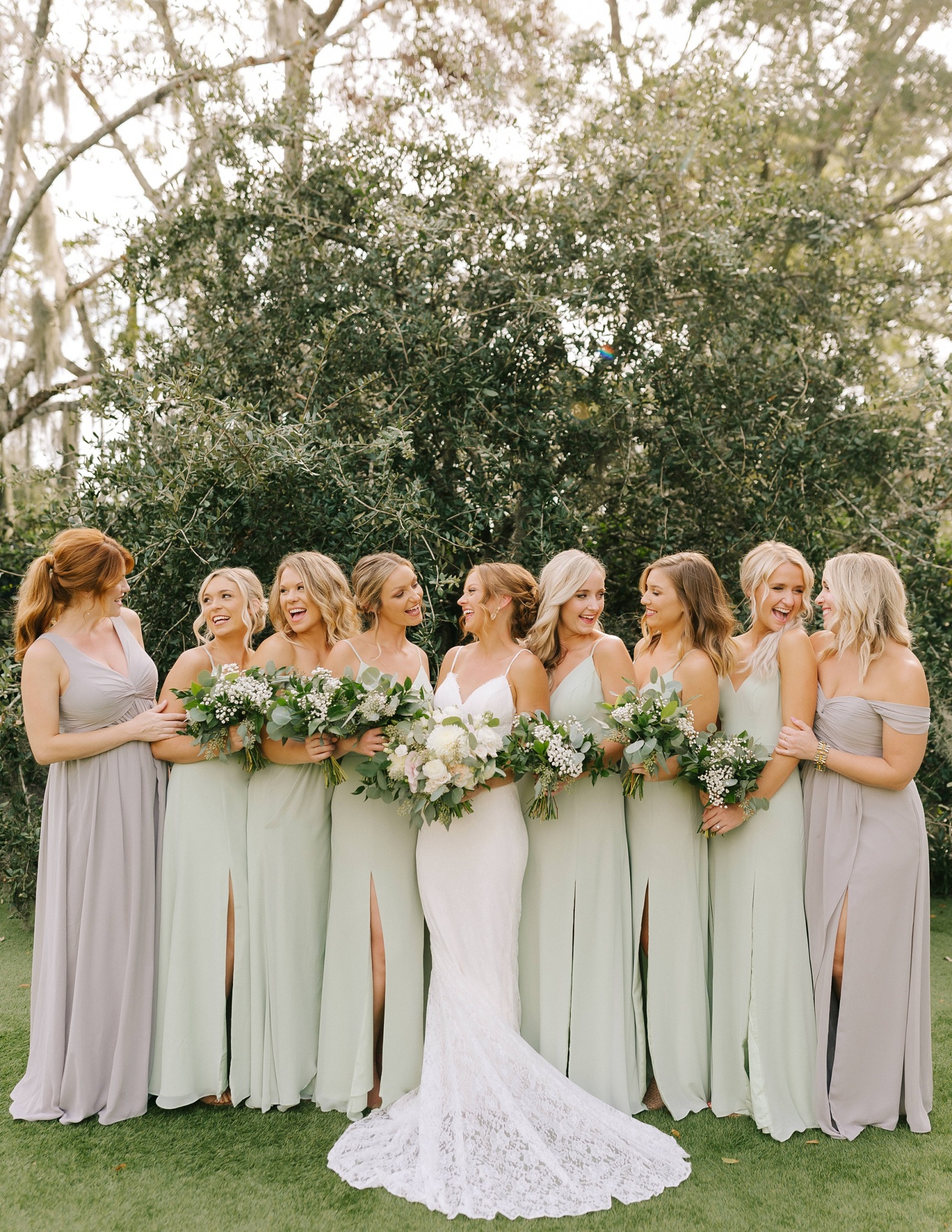 bride and bridesmaids pose in gardens at Wrightsville Manor