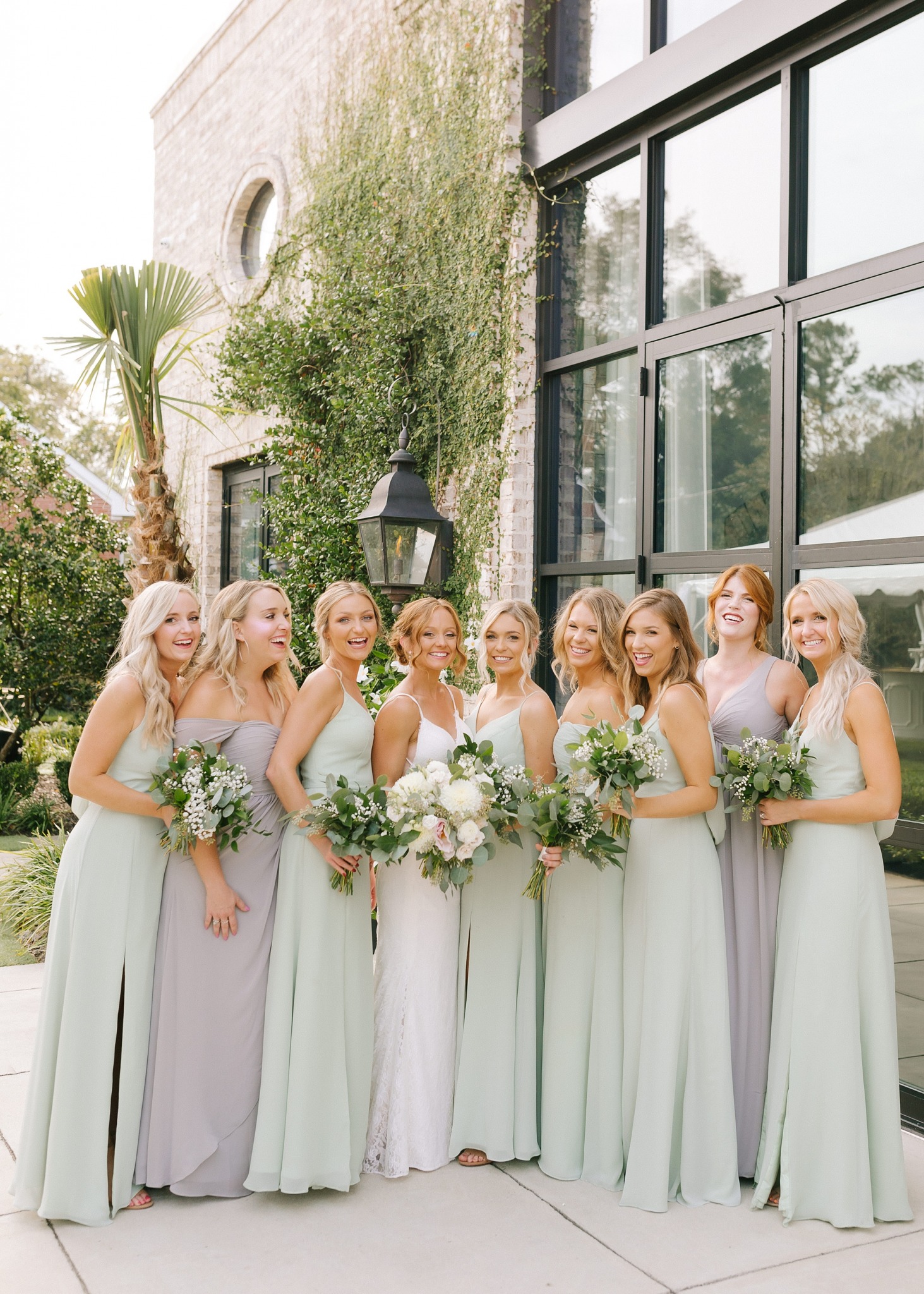 bridesmaids in mint gowns pose with bride