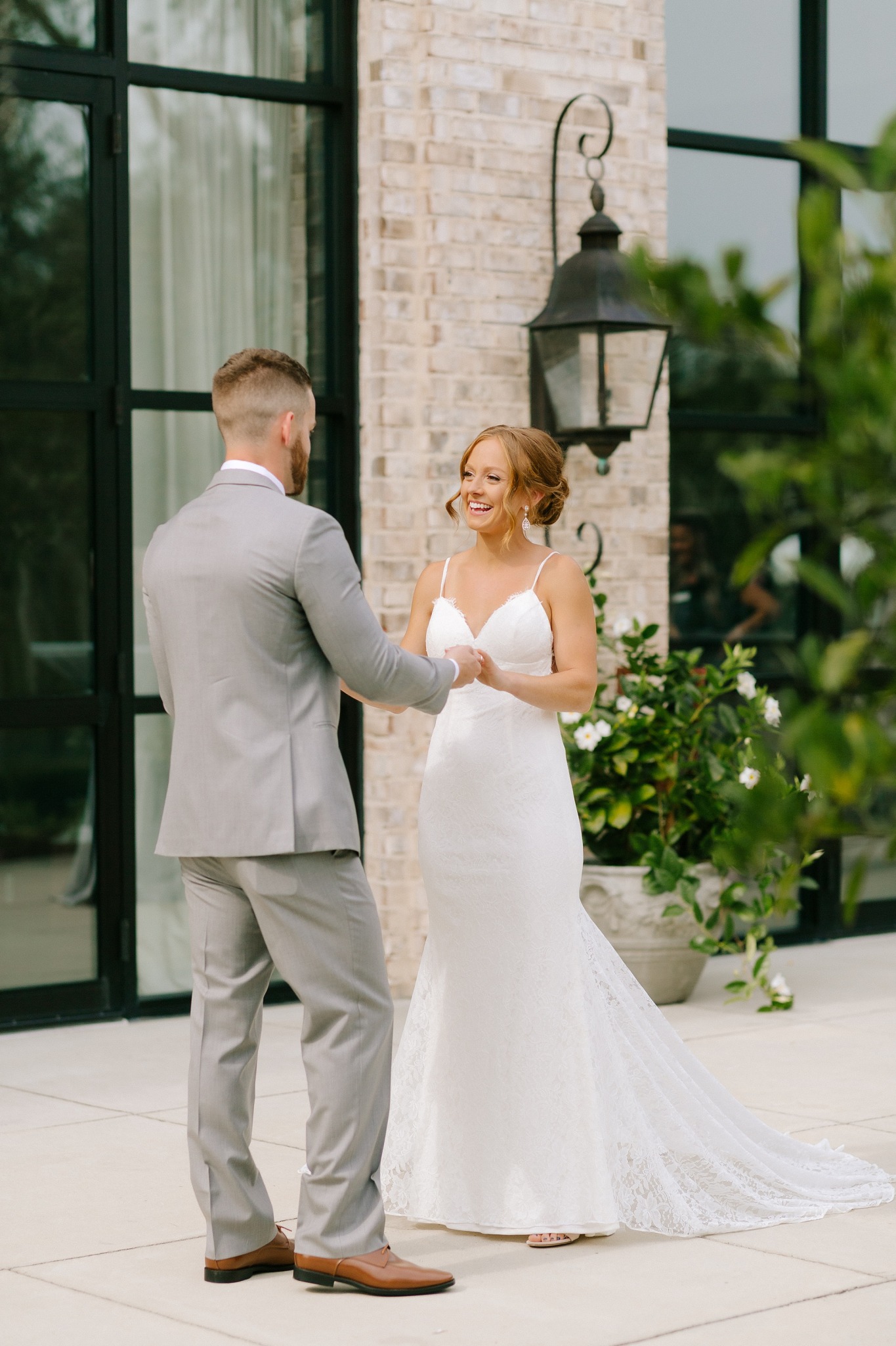 bride's reaction during first look on patio at Wrightsville Manor