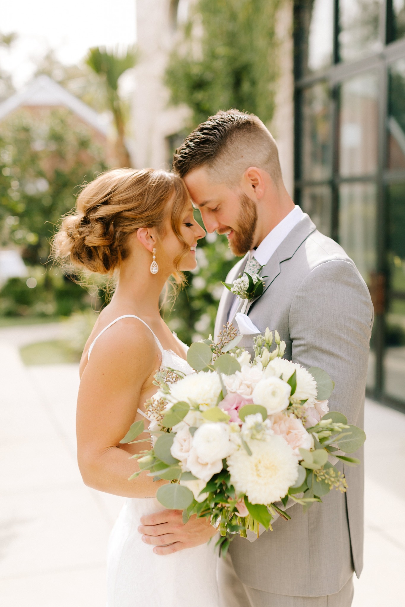 newlyweds stand with foreheads touching