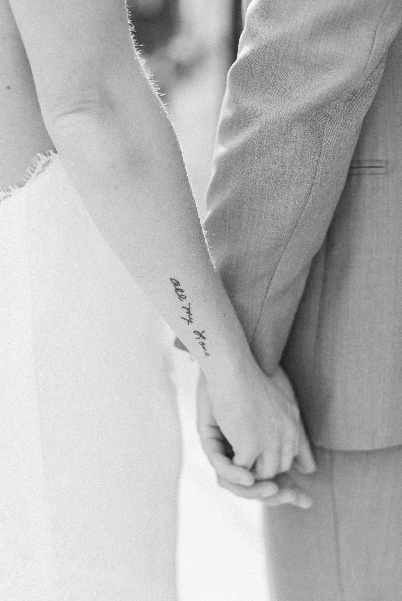 black and white portrait of bride and groom holding hands