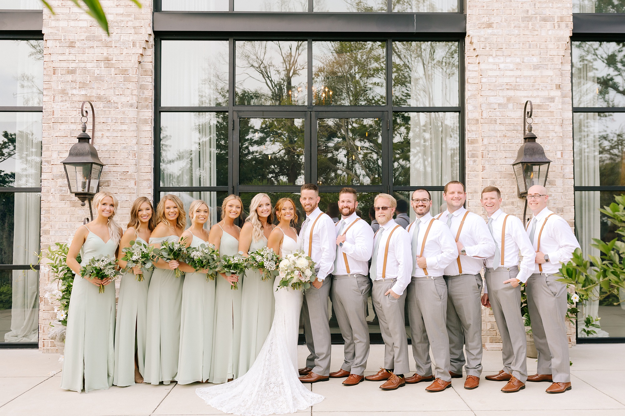 bride and groom pose with wedding party in NC