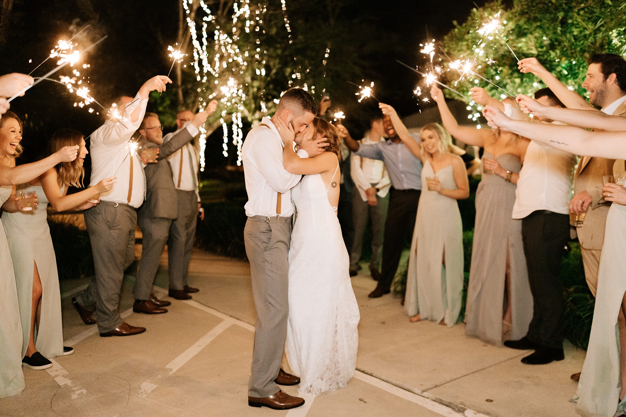 newlyweds kiss during Wilmington NC wedding reception sparkler exit