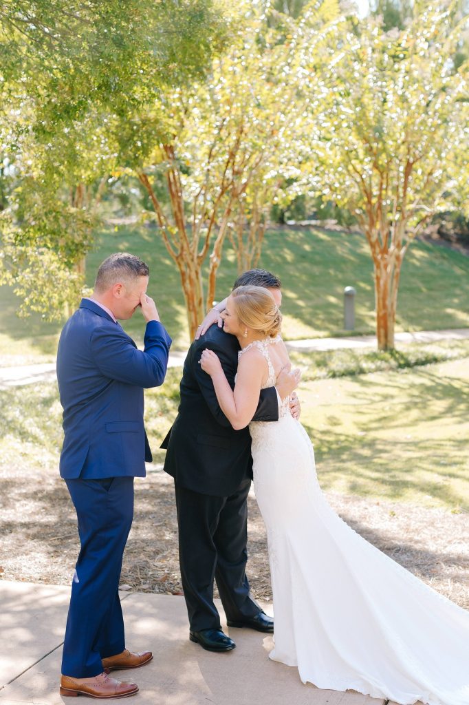 bride has first look with dad and brother