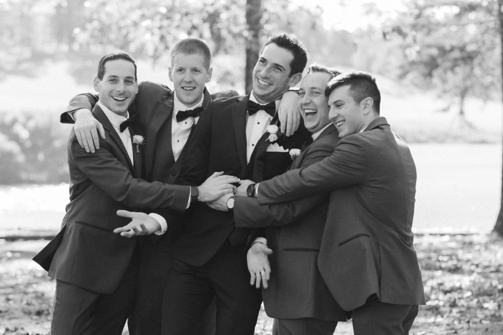 groomsmen hug groom during wedding photos