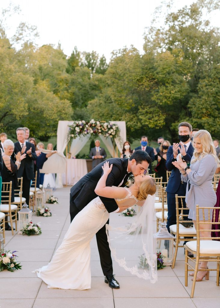 groom dips bride during kiss at Renaissance Ross Bridge