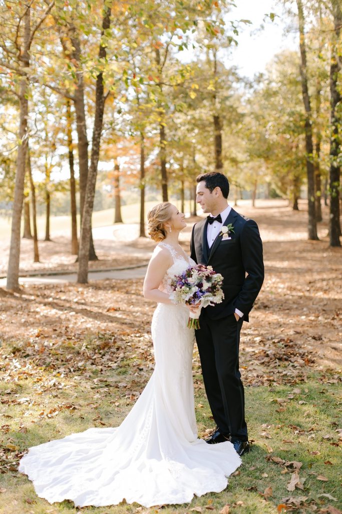 bride and groom pose in woods of Alabama