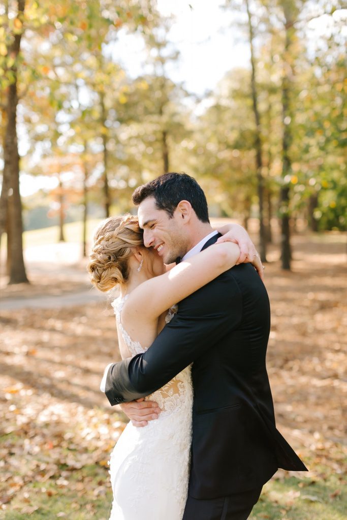 bride and groom hug during wedding photos in Alabama