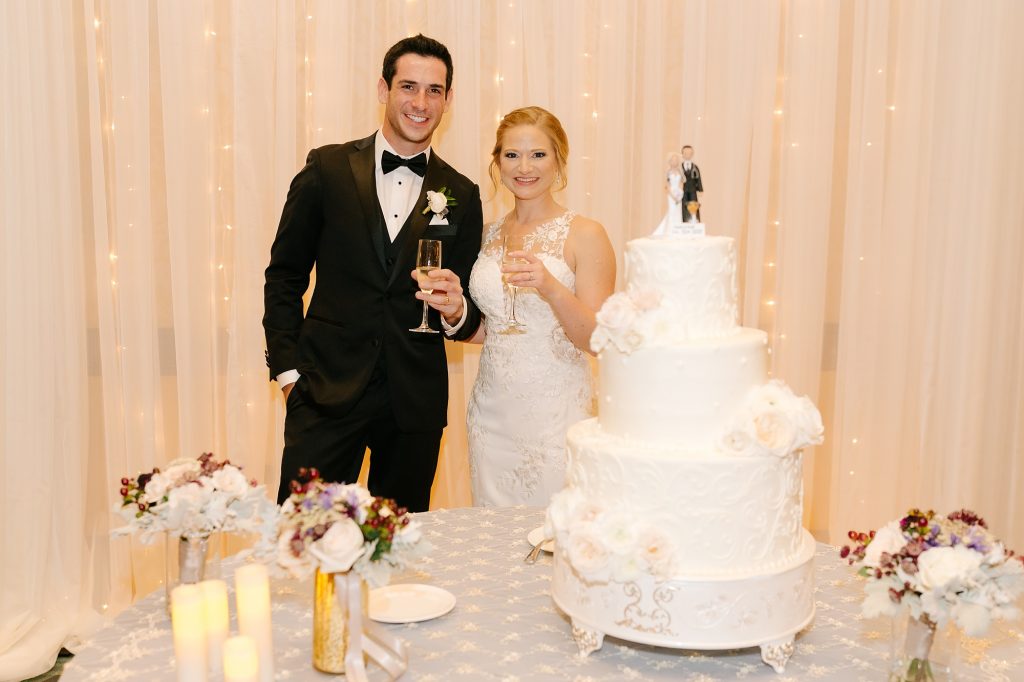 bride and groom cut wedding cake at Birmingham AL wedding reception