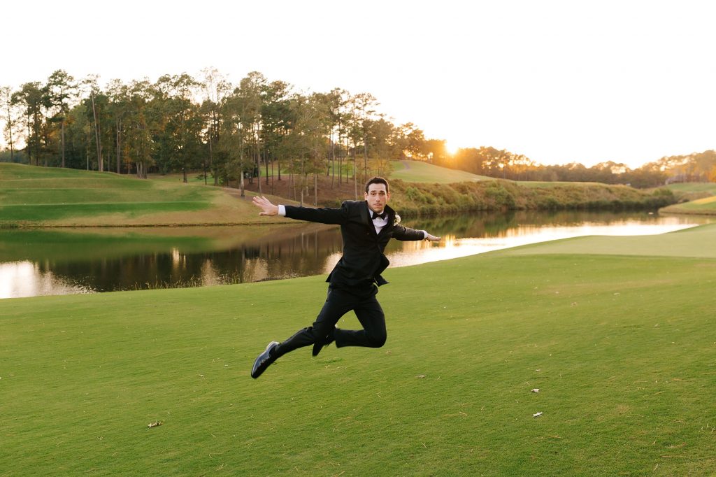 groom jumps on golf course at Renaissance Ross Bridge