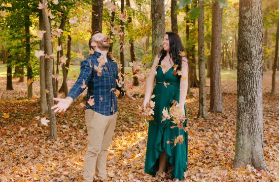 Playful couple throwing fall leaves in a photo taken by Winston Salem photographer Chelsea Renay
