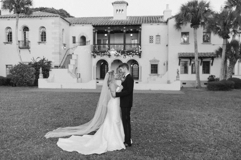 bride and groom pose outside Sarasota FL venue 