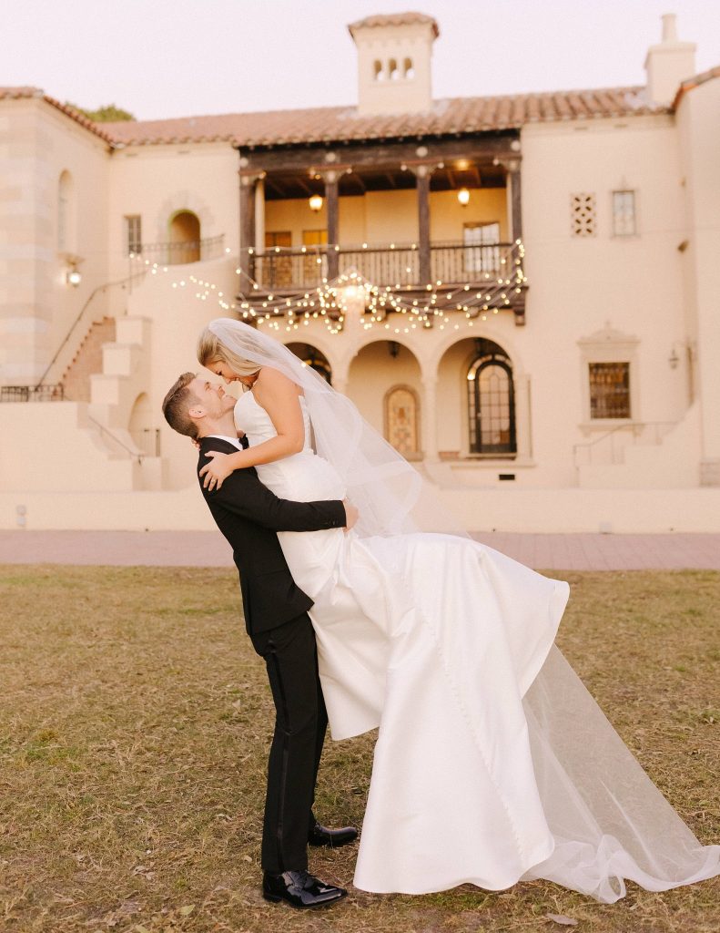 groom lifts bride during portraits before intimate ceremony at Powel Crosley Estate