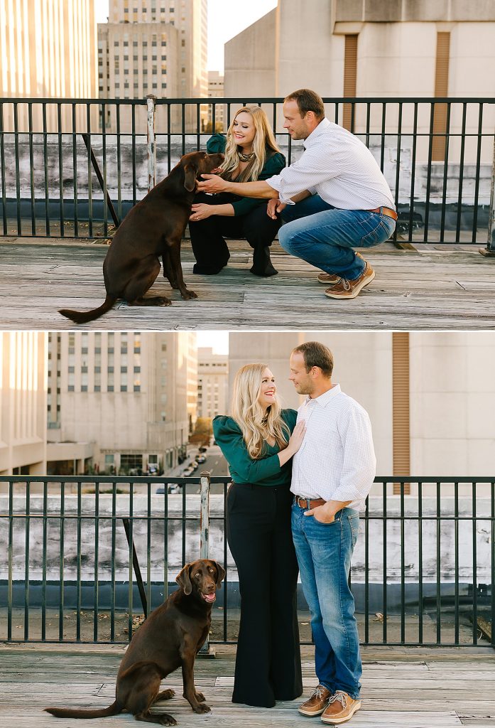 couple celebrating anniversary poses with dog on rooftop