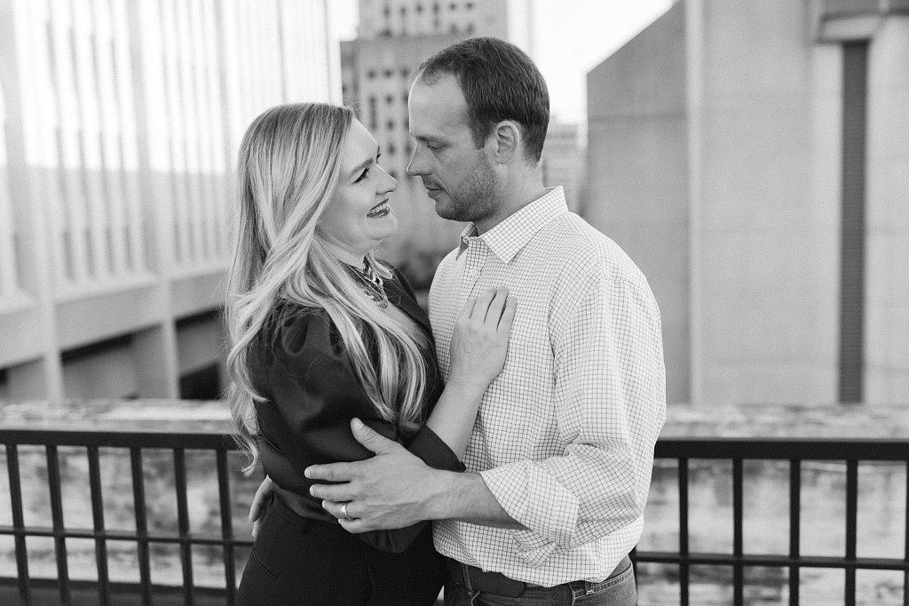 wife leans against husband and smiles at him during anniversary photos