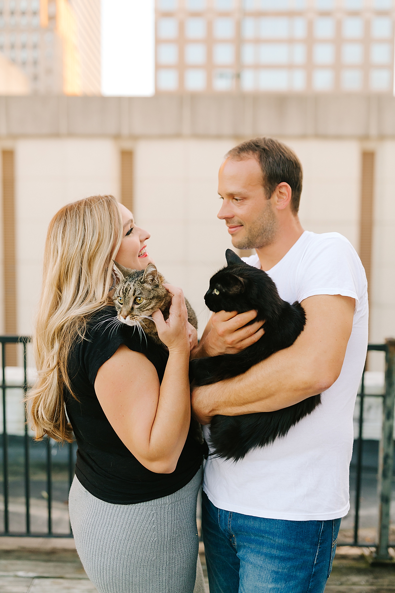 married couple holds cats during anniversary photos