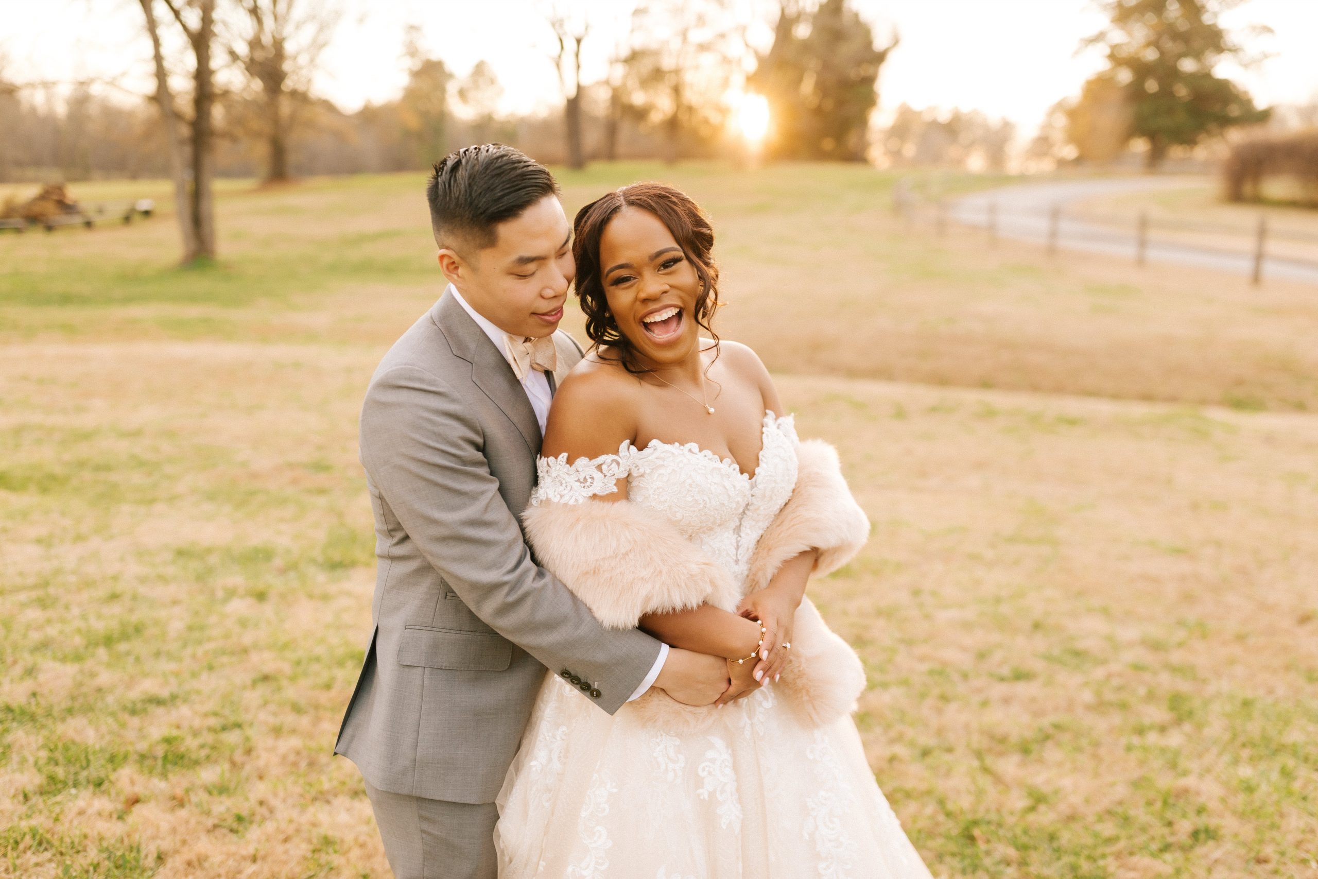 bride laughs with her husband on their wedding day in Raleigh, NC.