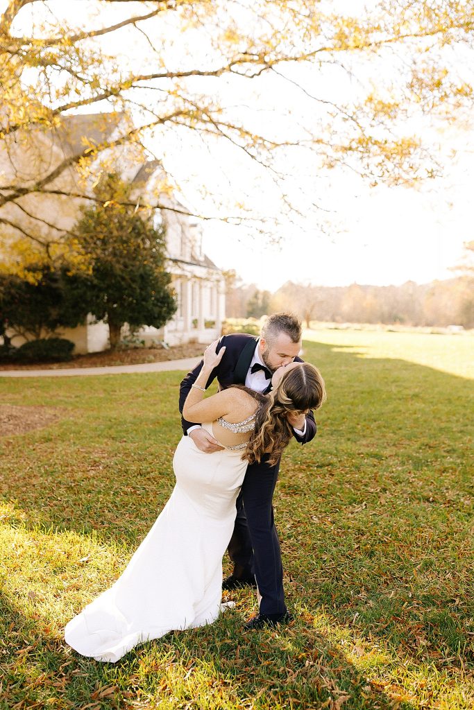 groom kisses bride and dips her during NC wedding