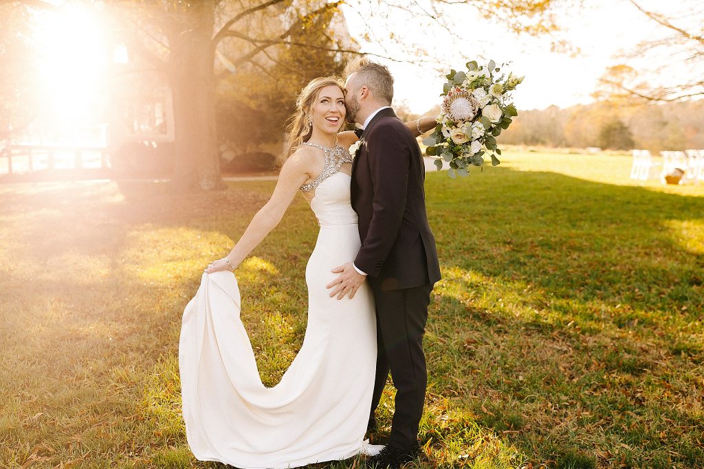 bride and groom laugh together at sunset at The Meadows Raleigh