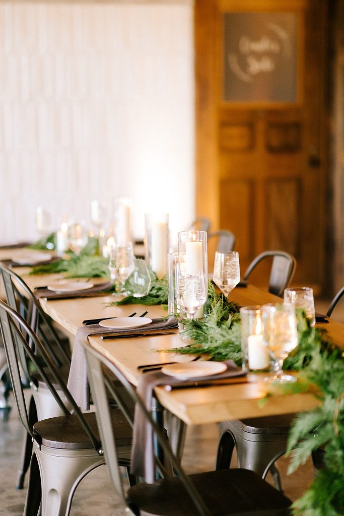 reception tables cape with tall candles and greenery