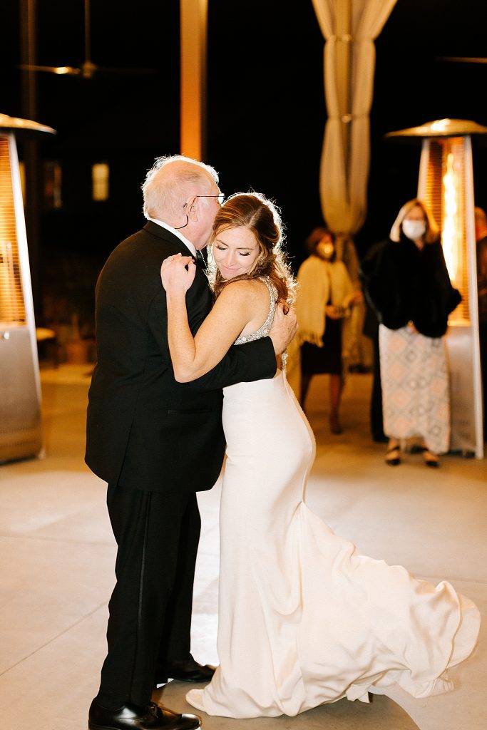 bride hugs dad during wedding reception