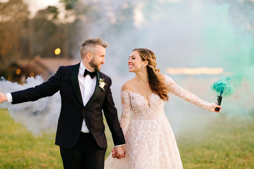 bride and groom walk with smoke bombs at The Meadows Raleigh