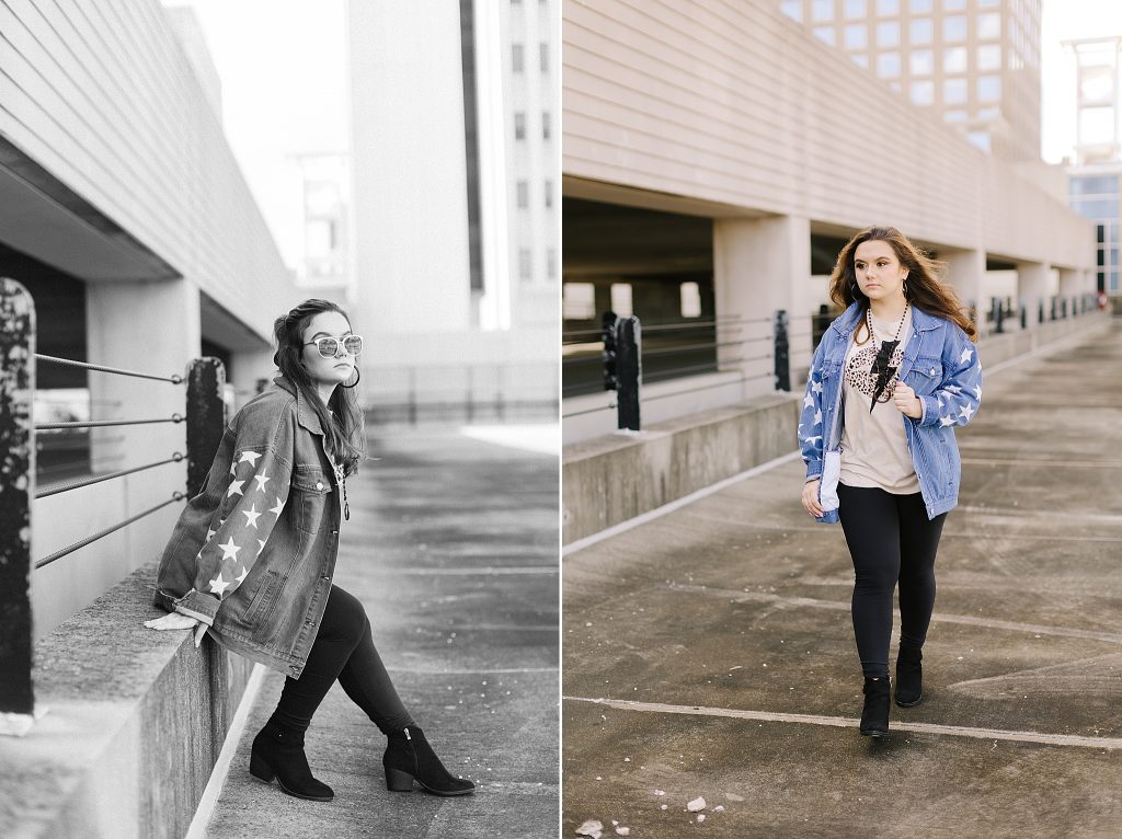 senior poses on parking garage in jean jacket