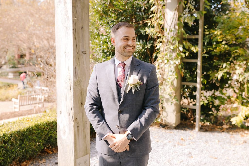 groom watches bride walk down the aisle during Atlanta garden ceremony