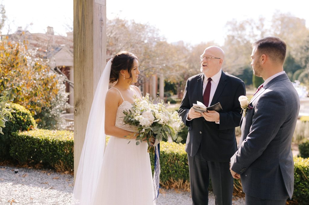 bride and groom listen to officiant during intimate ceremony in Downtown Atlanta