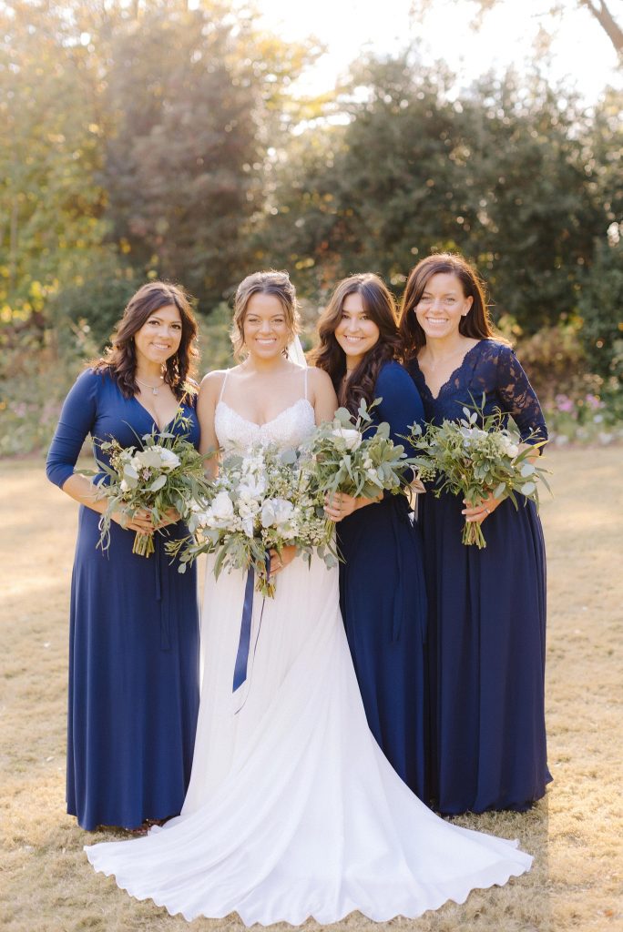 bride poses with bridesmaids in navy blue after intimate ceremony in Downtown Atlanta